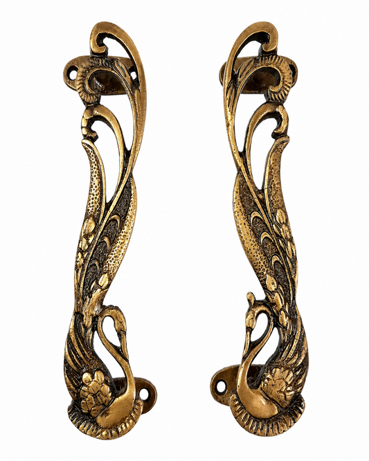 Pair of Brass gold Swan door handles on a white background