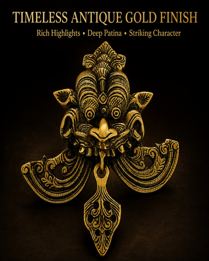 An ornate antique gold metal lion head door knocker with intricate scrollwork and a hanging bell, set against a dark black background with gold text reading 'TIMELESS ANTIQUE GOLD FINISH' and 'Rich Highlights • Deep Patina • Striking Character'.