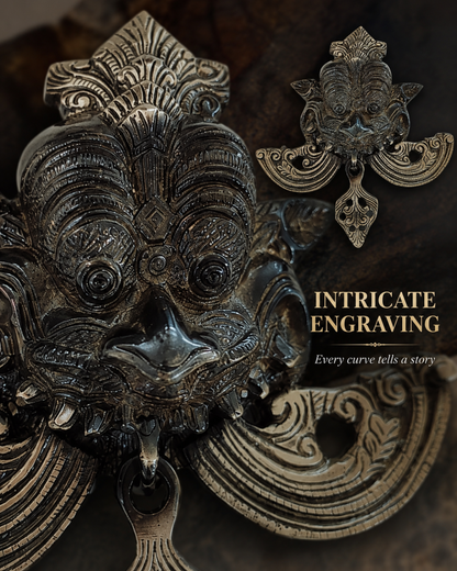 Close-up of an ornate metallic door knocker or wall hanging with intricate engraved detailing, shown against a dark textured background. A smaller matching decorative piece appears in the upper right, with the text 'INTRICATE ENGRAVING' and 'Every curve tells a story'.