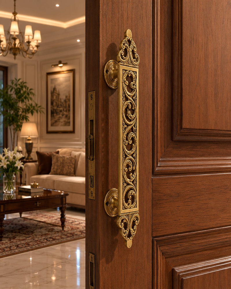 Decorative gold handle on a wooden door leading to a living room.