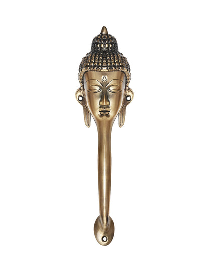 Decorative Buddha face brass handle on a white background.