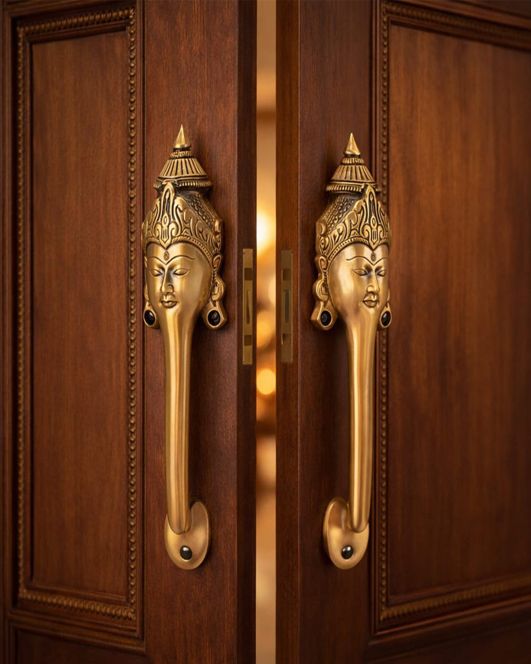 Decorative Brass door handle with face design on a wooden door