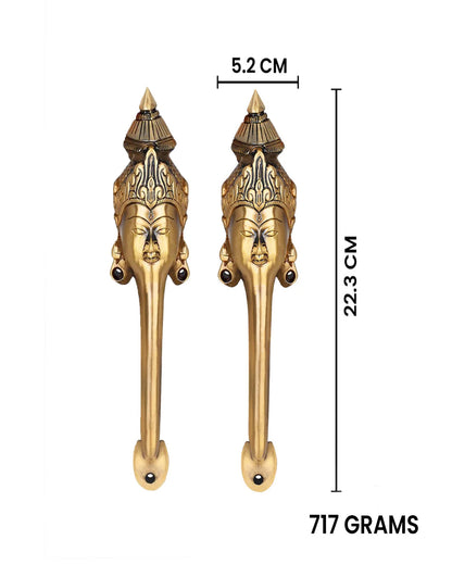 Pair of decorative brass door handles with measurements.