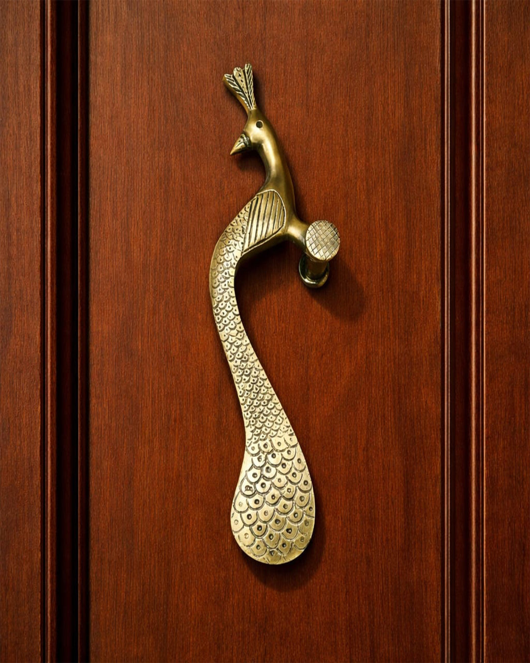 Brass peacock door handle.