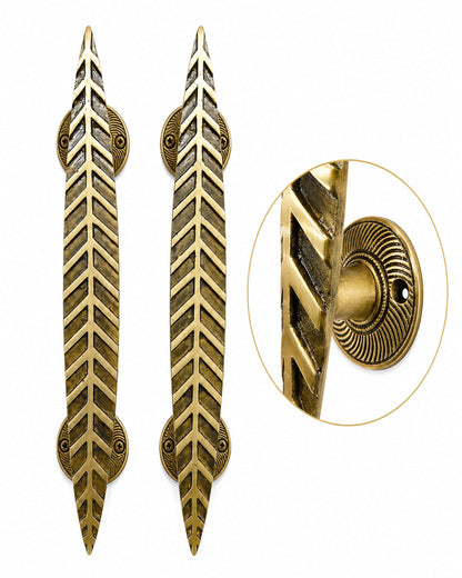 Two brass door pull handles with a leaf-like chevron pattern, shown on a white background.