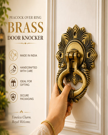 A hand wearing a gold bracelet holds a brass peacock-themed door knocker against a white door. The left side features a text panel with product details: 'PEACOCK OVER RING BRASS DOOR KNOCKER', 'MADE IN INDIA', 'HANDCRAFTED WITH CARE', 'IDEAL FOR GIFTING', and 'SECURE PACKAGING'.