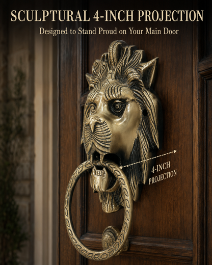 A lion head door knocker in an antique brass finish with a circular ring, mounted on a dark wood door. The image includes text overlays reading 'SCULPTURAL 4-INCH PROJECTION' and 'Designed to Stand Proud on Your Main Door' with a dashed line indicating the 4-inch projection.