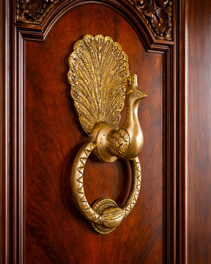 Gold peacock door knocker on a wooden door