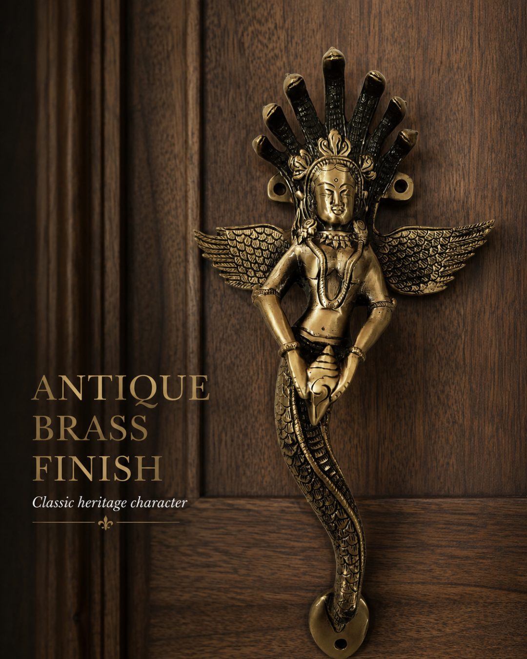 An antique brass door handle shaped like a winged deity with a serpent-like lower body, mounted on a dark wood door. The image includes text on the left reading 'ANTIQUE BRASS FINISH' and 'Classic heritage character'.
