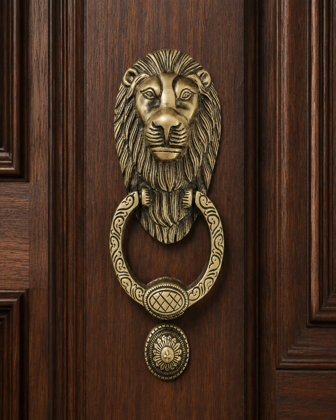 An ornate brass lion head door knocker with a matching ring and round doormat, mounted on a dark brown wooden door.