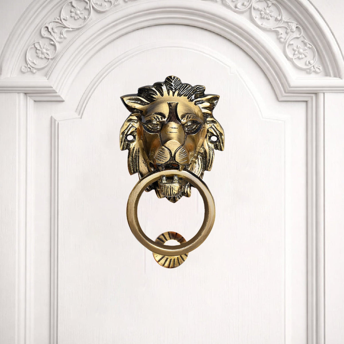 Gold lion-shaped door knocker on a white door