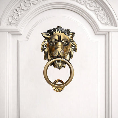 Gold lion-shaped door knocker on a white door